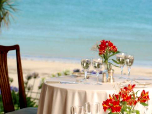 A table set in The Nare hotel's dining room, with views of the Cornish coast.