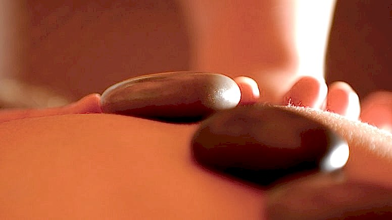 A hot-stone massage treatment.