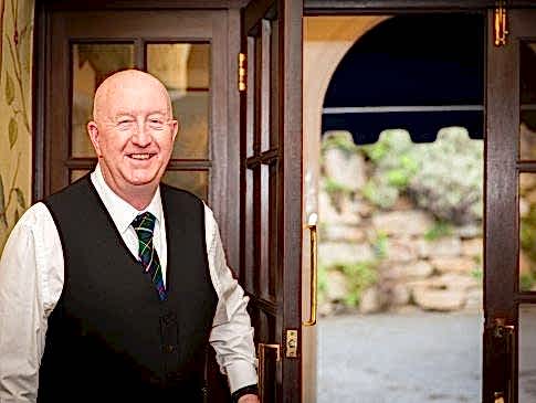 The Nare's concierge smiles as he opens the hotel doors.